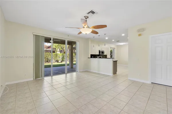 a view of a kitchen with furniture and an empty room