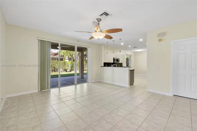 a view of a kitchen with furniture and an empty room