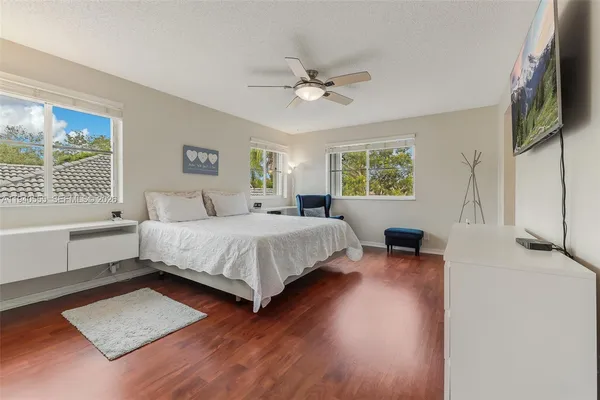 a bedroom with a bed lamps and window