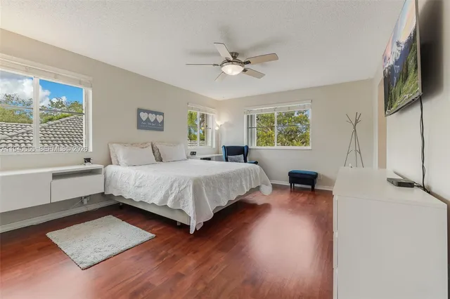 a bedroom with a bed lamps and window