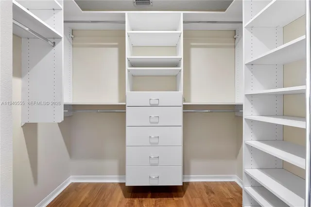 a view of walk in closet with empty racks