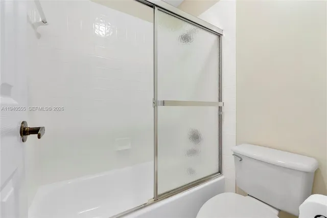 a bathroom with a shower and a toilet
