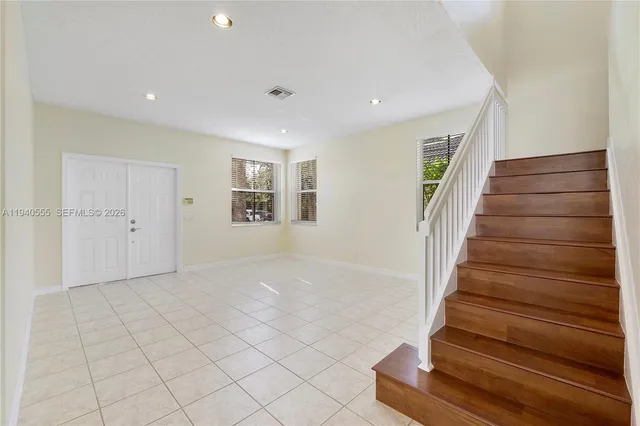 a view of entryway with wooden floor and stairs