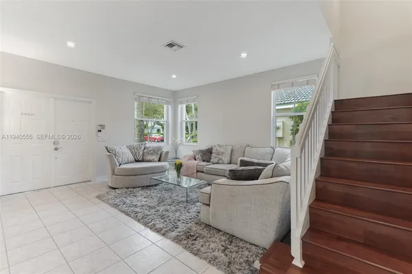 a living room with furniture and wooden floor