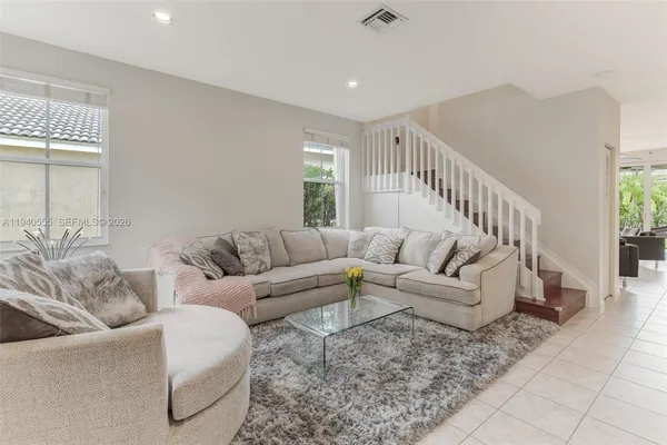 a living room with furniture and stairs