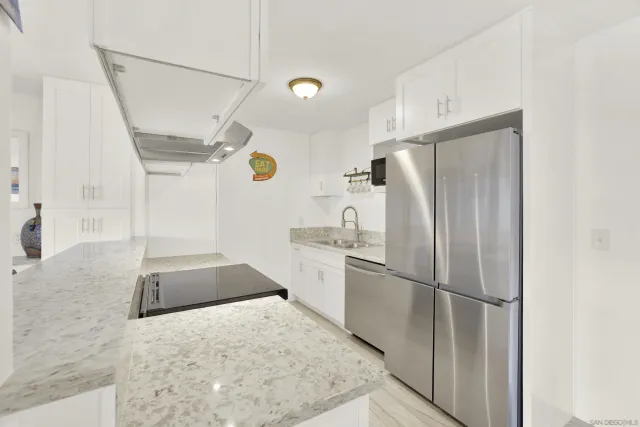 a kitchen with a refrigerator and a sink