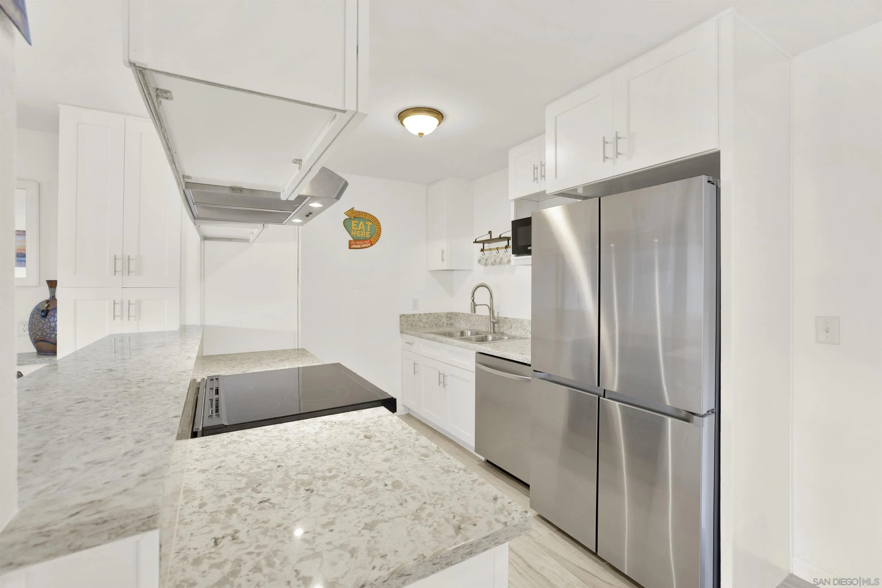 6780 Friars Road, Unit 153 San Diego, CA 92108 - Photo 2 of 21 a kitchen with a refrigerator and a sink