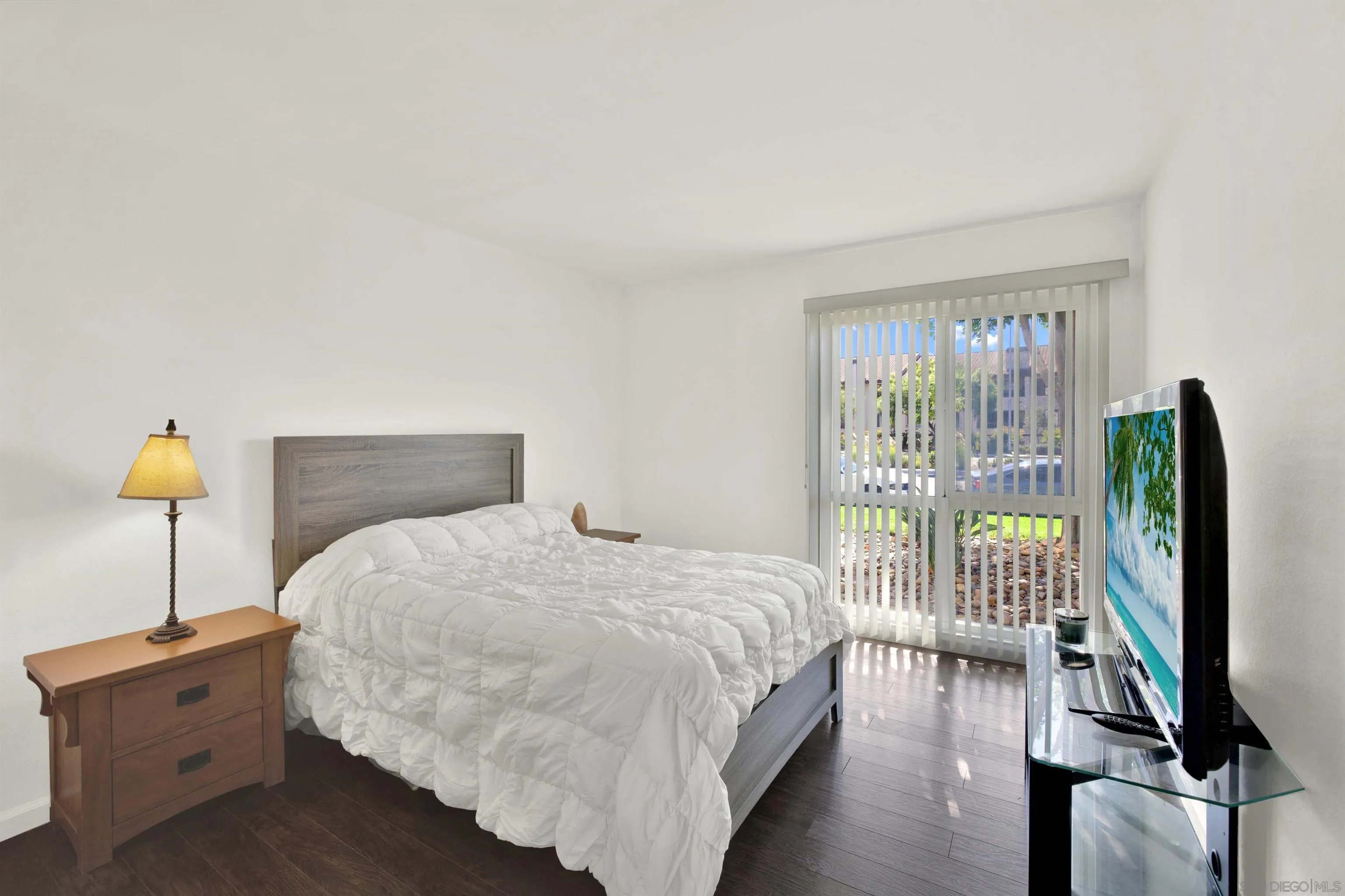 6780 Friars Road, Unit 153 San Diego, CA 92108 - Photo 8 of 21 a bedroom with a bed and a flat tv screen on dresser