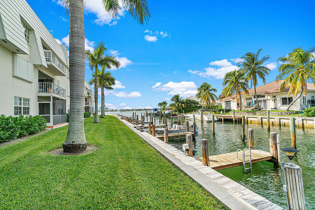 1030 Sugar Sands Boulevard, Unit 171 Singer Island, FL 33404 - Photo 1 of 20 a view of a lake with a garden