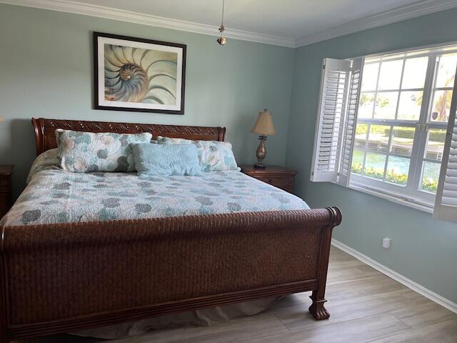 1030 Sugar Sands Boulevard, Unit 171 Singer Island, FL 33404 - Photo 11 of 20 a large bed sitting in a bedroom next to a window