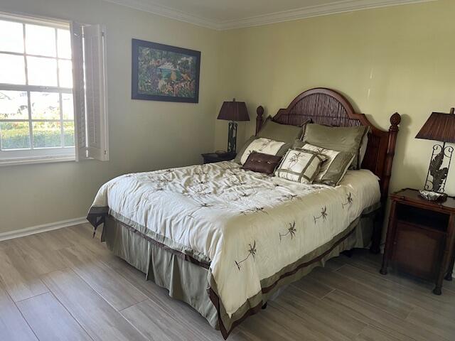 1030 Sugar Sands Boulevard, Unit 171 Singer Island, FL 33404 - Photo 16 of 20 a bedroom with a bed and wooden floor