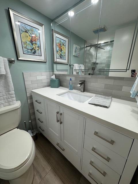 1030 Sugar Sands Boulevard, Unit 171 Singer Island, FL 33404 - Photo 18 of 20 a bathroom with a granite countertop sink mirror vanity and toilet