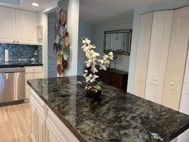 1030 Sugar Sands Boulevard, Unit 171 Singer Island, FL 33404 - Photo 5 of 20 a kitchen with a refrigerator and a stove top oven