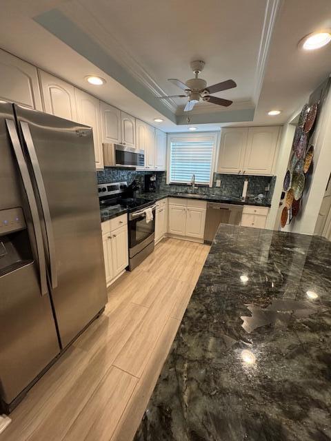 1030 Sugar Sands Boulevard, Unit 171 Singer Island, FL 33404 - Photo 8 of 20 a large kitchen with stainless steel appliances kitchen island granite countertop a refrigerator a sink and a stove