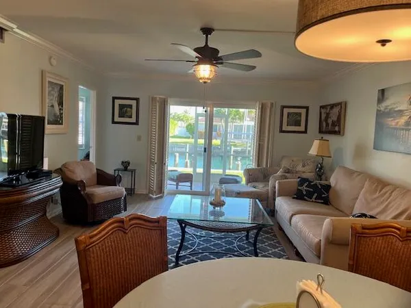 a view of a dining room with furniture a chandelier and wooden floor