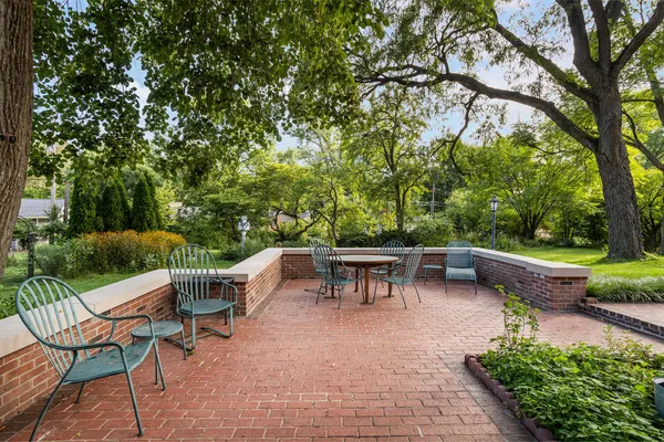 a view of a patio with furniture and garden