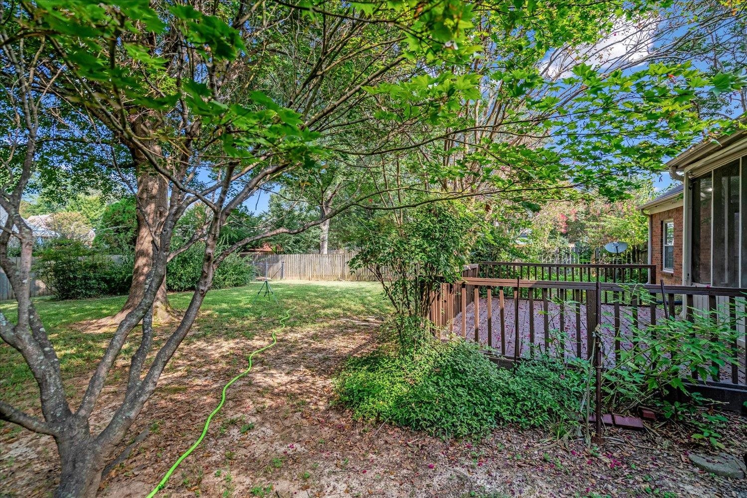 1665 Riverdale Road Germantown, TN 38138 - Photo 39 of 39 a view of a backyard with large trees and wooden fence