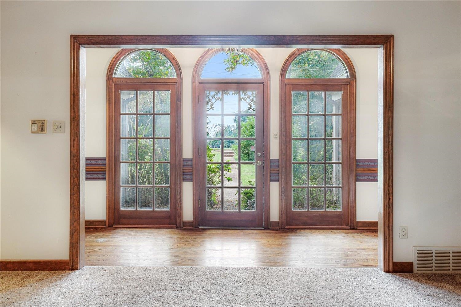 1665 Riverdale Road Germantown, TN 38138 - Photo 7 of 39 an empty room with wooden floor and windows