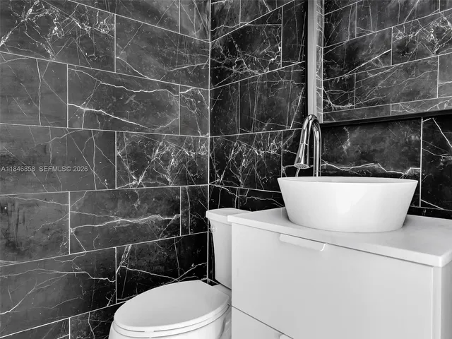 a bathroom with a toilet a sink and a mirror