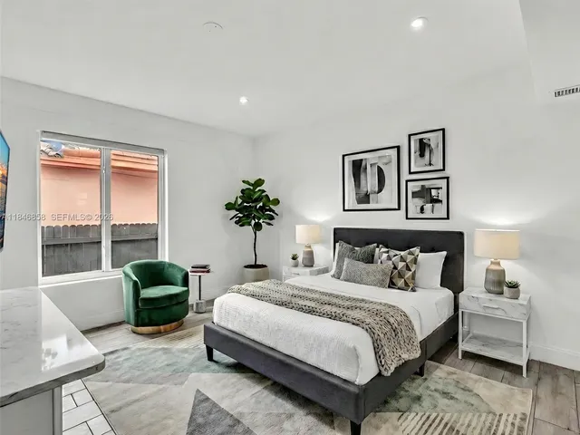 a bedroom with a large bed and a couch