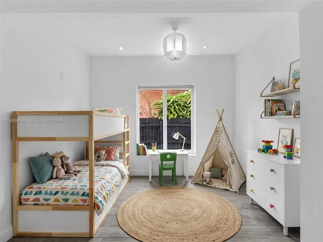 a bedroom with a bed furniture and window