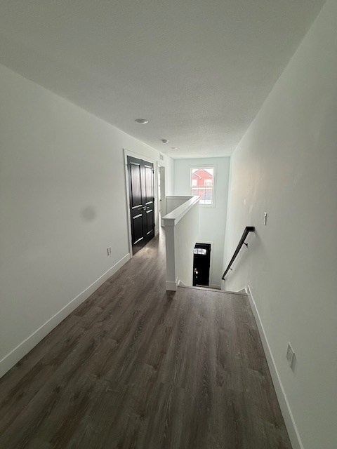 3304 Stoneway Court Champaign, IL 61822 - Photo 8 of 10 a view of a hallway with wooden floor and staircase