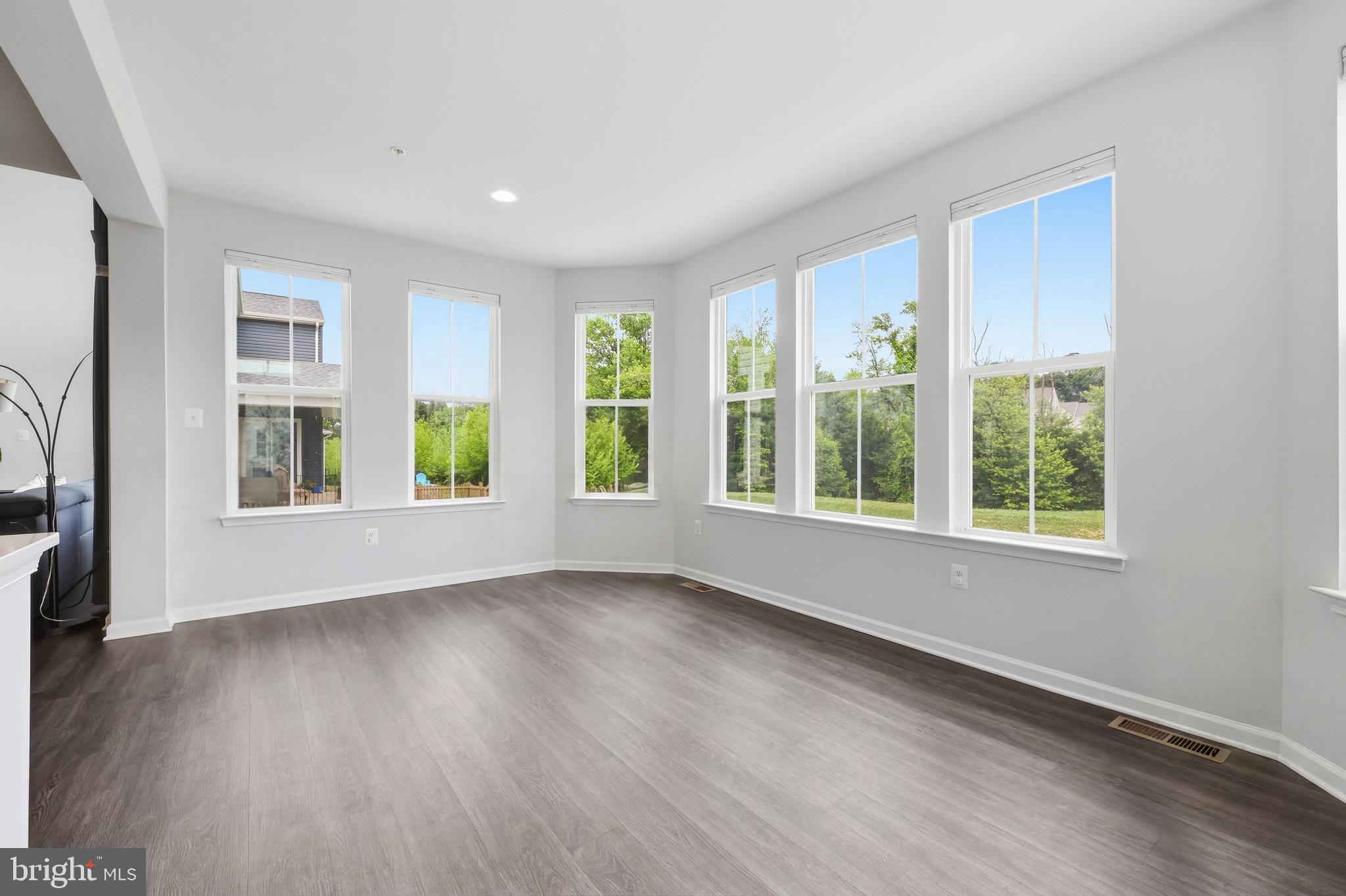 5707 Hawk Ridge Road Frederick, MD 21704 - Photo 16 of 109 a view of an empty room with wooden floor and a window