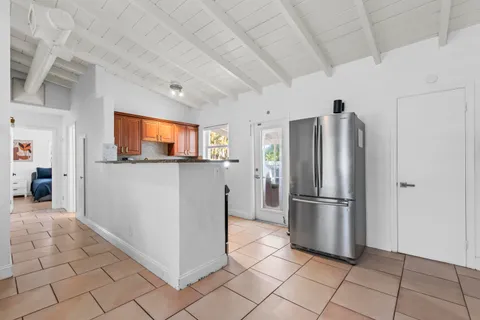 a kitchen with stainless steel appliances granite countertop a refrigerator and a stove