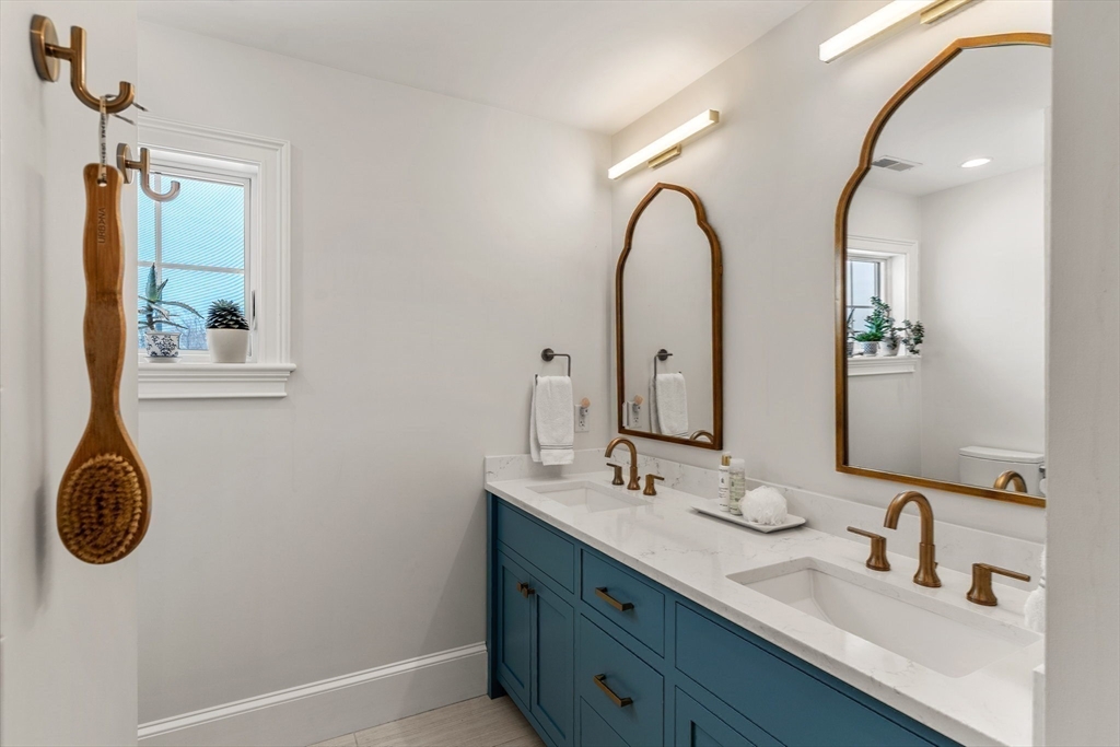 2 Chebacco Road Ipswich, MA 01938 - Photo 39 of 42 a bathroom with a granite countertop double vanity sink and a mirror