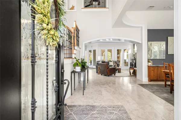 a view of a hallway with dining area and chandelier