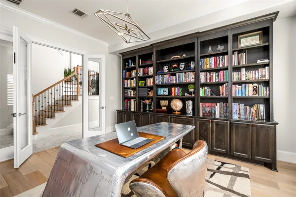 a living room with lots of furniture and a book shelf