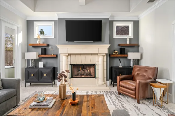 a living room with furniture and a fireplace