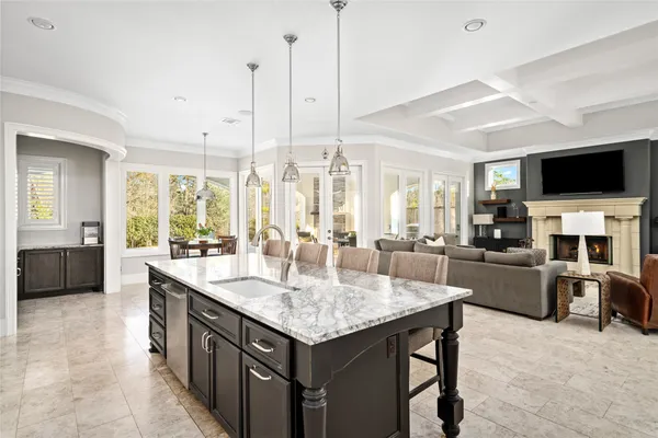 a kitchen with stainless steel appliances kitchen island granite countertop a table and chairs in it