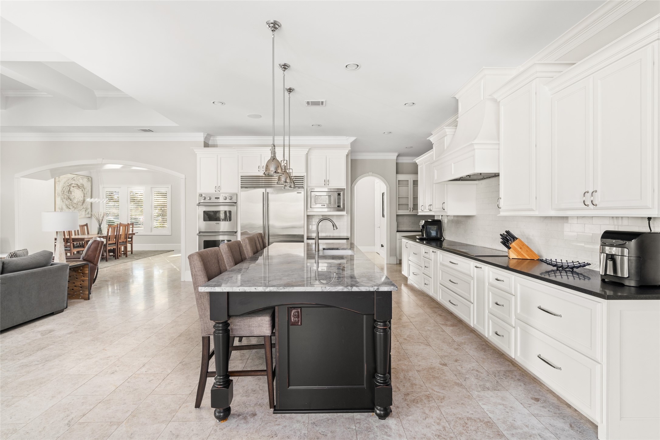 64 South Parkgate Circle Spring, TX 77381 - Photo 25 of 50 a kitchen with stainless steel appliances kitchen island granite countertop a table chairs sink and cabinets