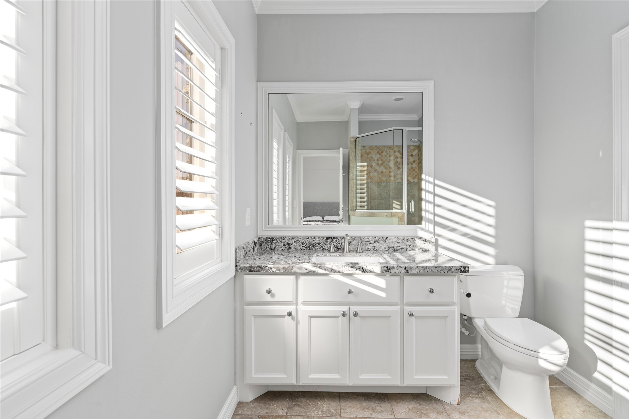 64 South Parkgate Circle Spring, TX 77381 - Photo 32 of 50 a bathroom with a granite countertop toilet a sink and a mirror