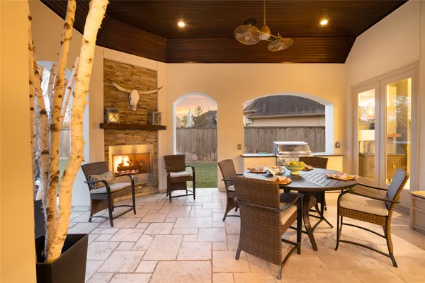 a dining room with furniture a chandelier and a rug