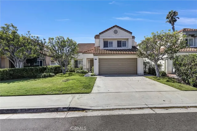 a front view of a house with a yard and a garage