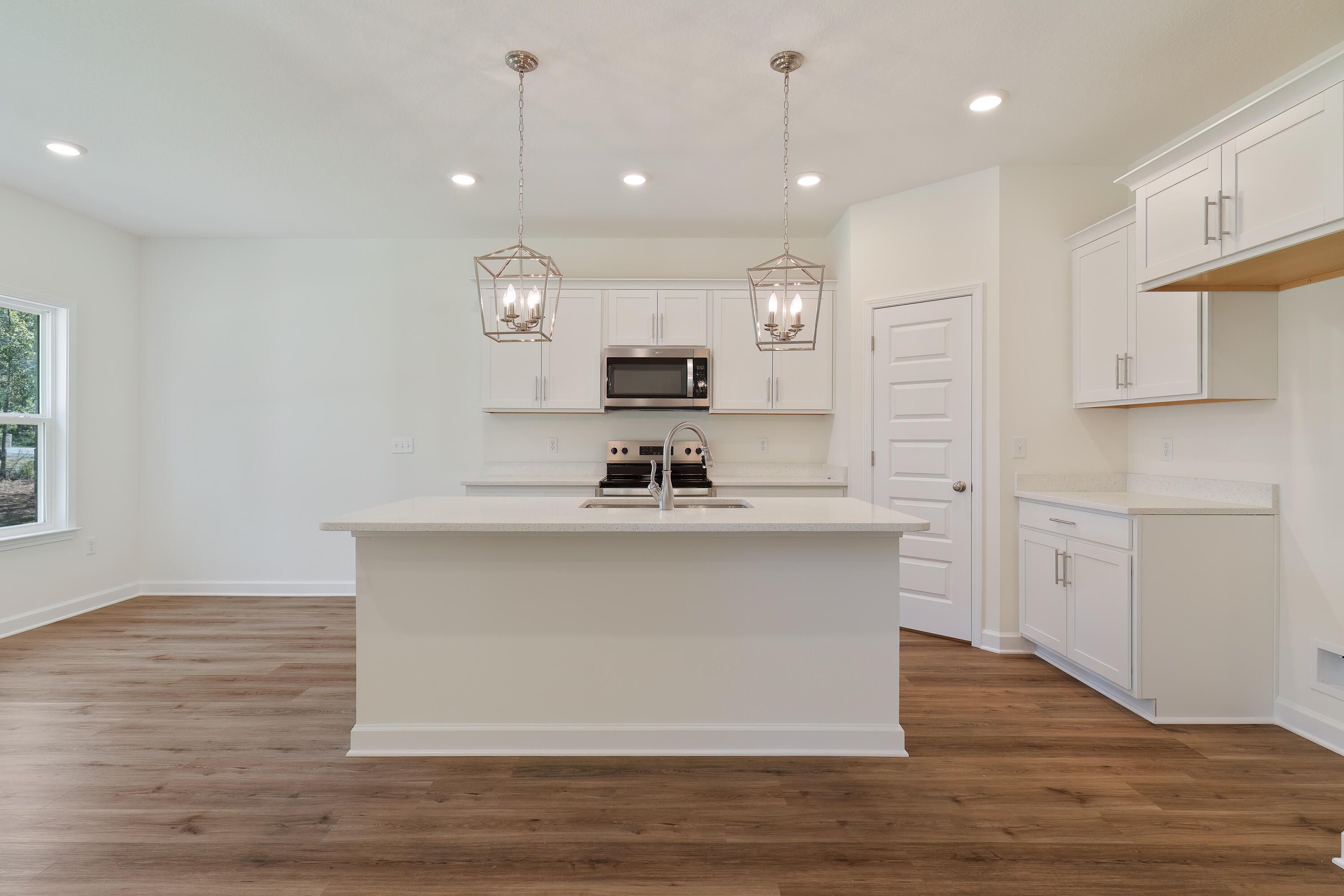 2831 Blackbird Court Crestview, FL 32539 - Photo 8 of 19 a kitchen with kitchen island a sink stainless steel appliances and cabinets