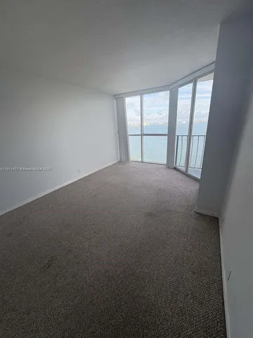 a view of empty room with floor to ceiling window