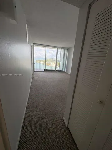 a view of an empty room with windows