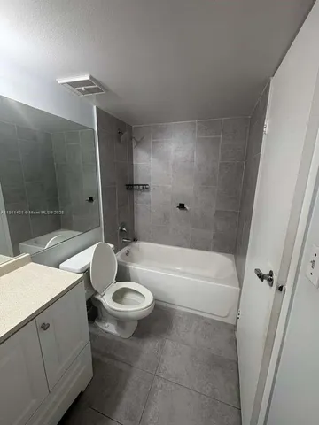 a view of an empty room and a window