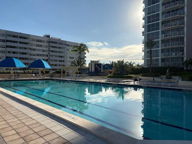 a swimming pool with outdoor seating and yard