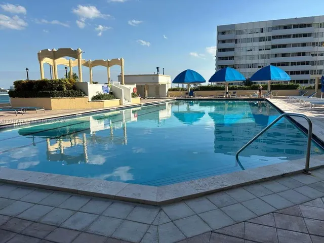 a view of a swimming pool with a table and chairs