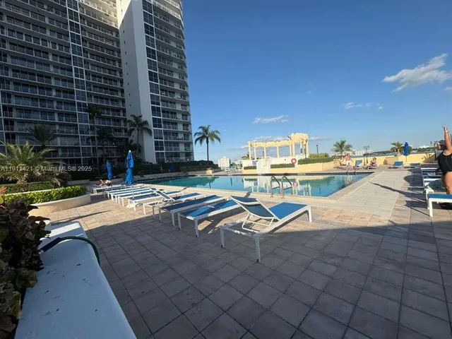 a view of outdoor space with swimming pool and trees in the background