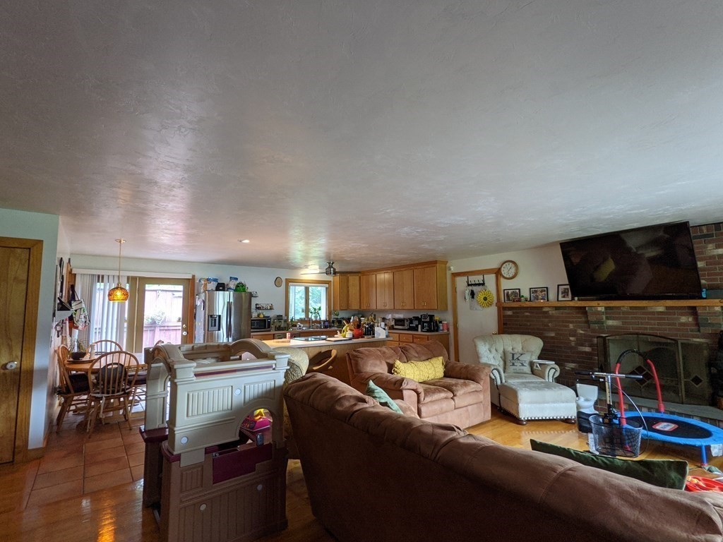 116-120 Thompson Road Webster, MA 01570 - Photo 2 of 39 a living room with furniture and a flat screen tv