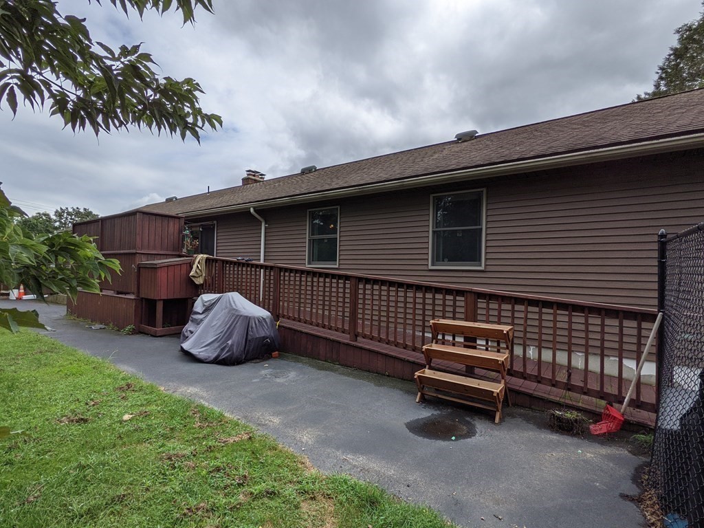 116-120 Thompson Road Webster, MA 01570 - Photo 28 of 39 a blue bench sitting in front of a house