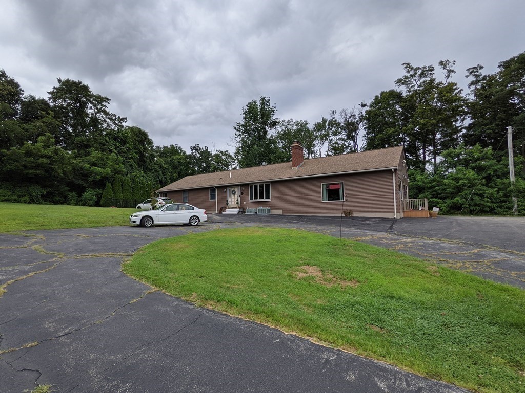 116-120 Thompson Road Webster, MA 01570 - Photo 30 of 39 a front view of a house with garden