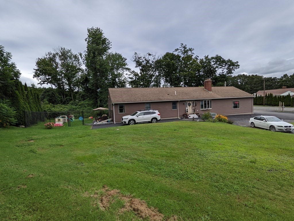 116-120 Thompson Road Webster, MA 01570 - Photo 32 of 39 a front view of a house with garden
