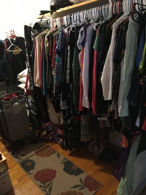 116-120 Thompson Road Webster, MA 01570 - Photo 8 of 39 a view of walk in closet with clothes and shoes