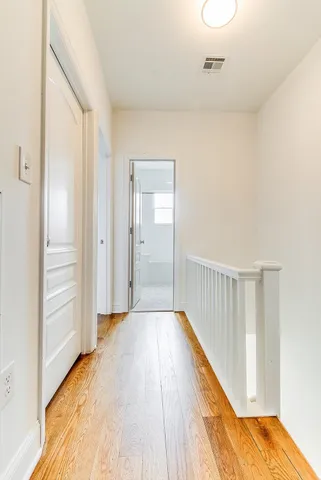 a view of a hallway with wooden floor